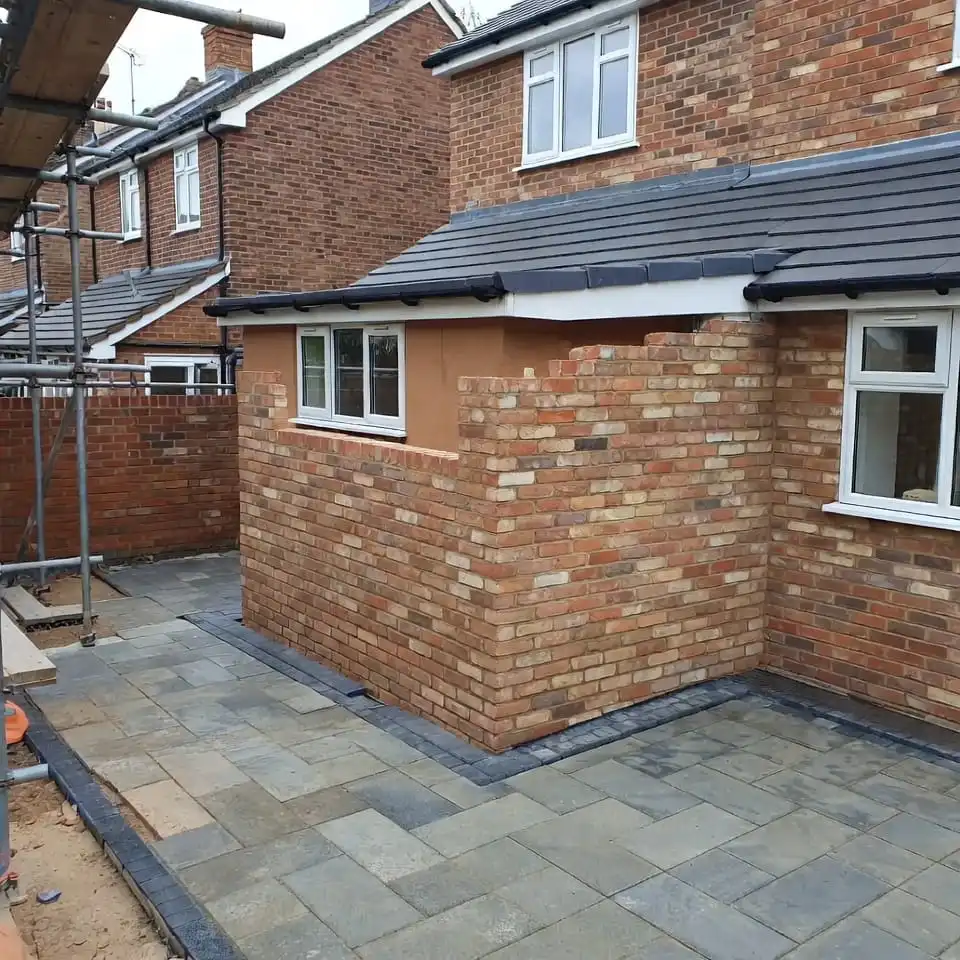Rear house extension with brickwork and paved patio external works completed in London