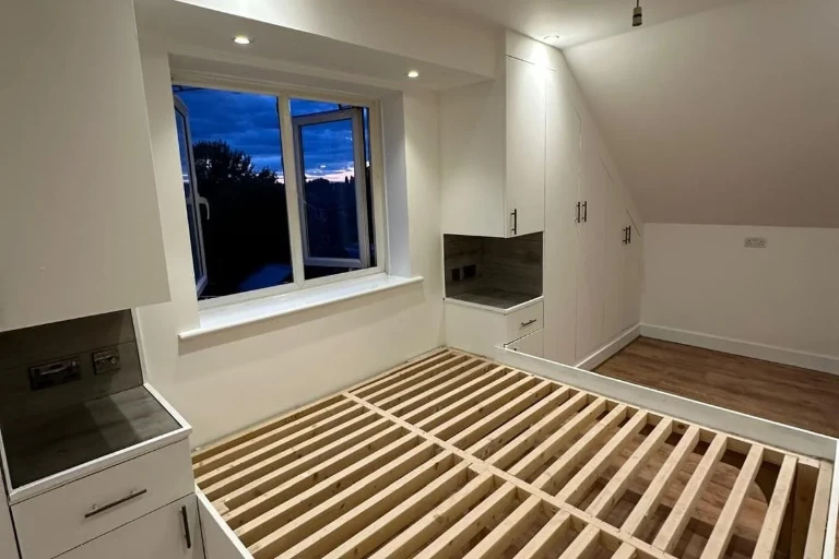 Loft bedroom renovation with fitted wardrobes and custom built-in bed frame