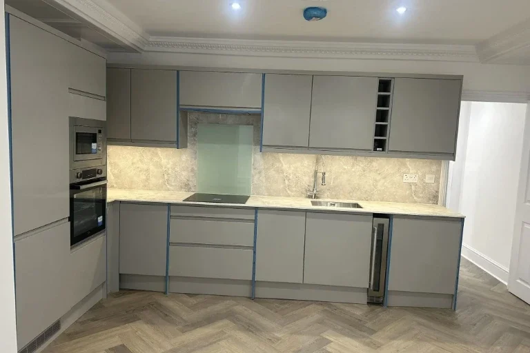 Modern grey kitchen with fitted units, stone-effect worktops and integrated appliances