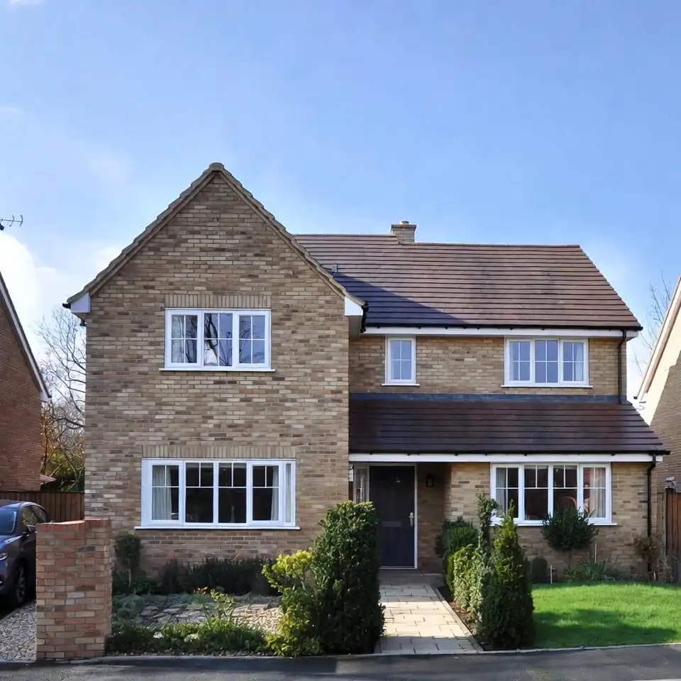 New build residential home in London with modern brick exterior and front garden