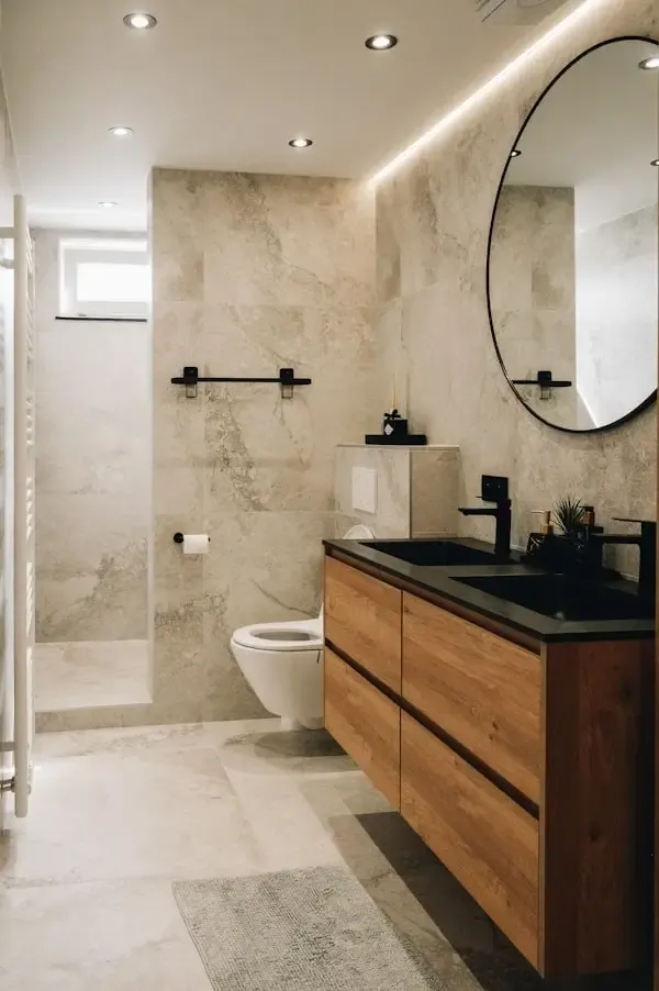 Premium bathroom renovation with walk-in shower, stone-effect tiling and floating oak and black vanity unit, London