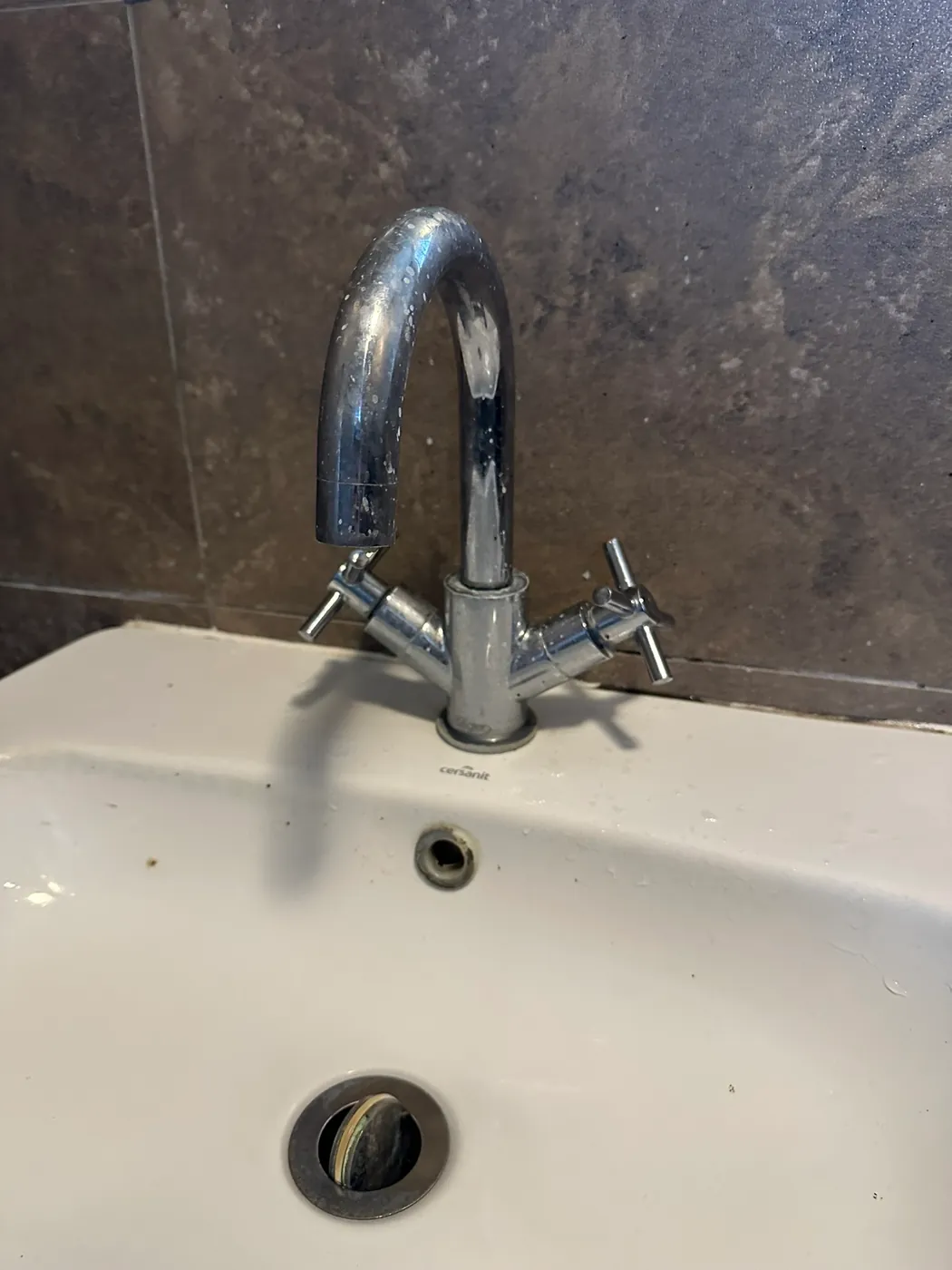 Old two-handle basin tap before replacement in a Deptford flat