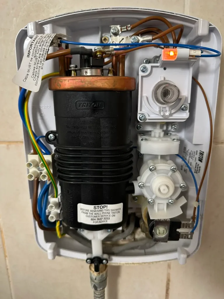 The electric shower opened up for replacement, Deptford