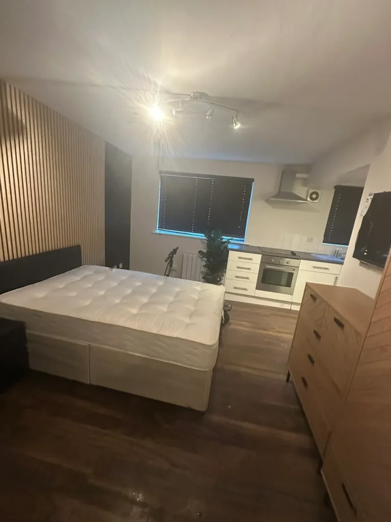 The studio room finished, with a slatted feature wall behind the bed, Deptford