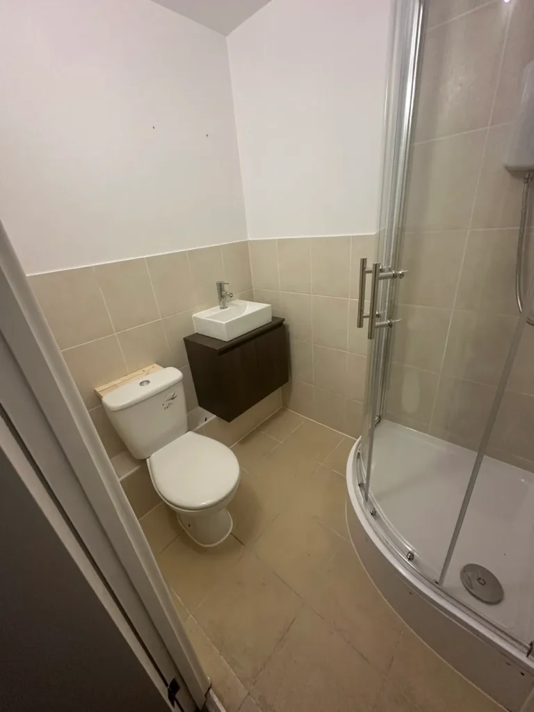 The refitted shower room with a wall-hung basin unit, Deptford