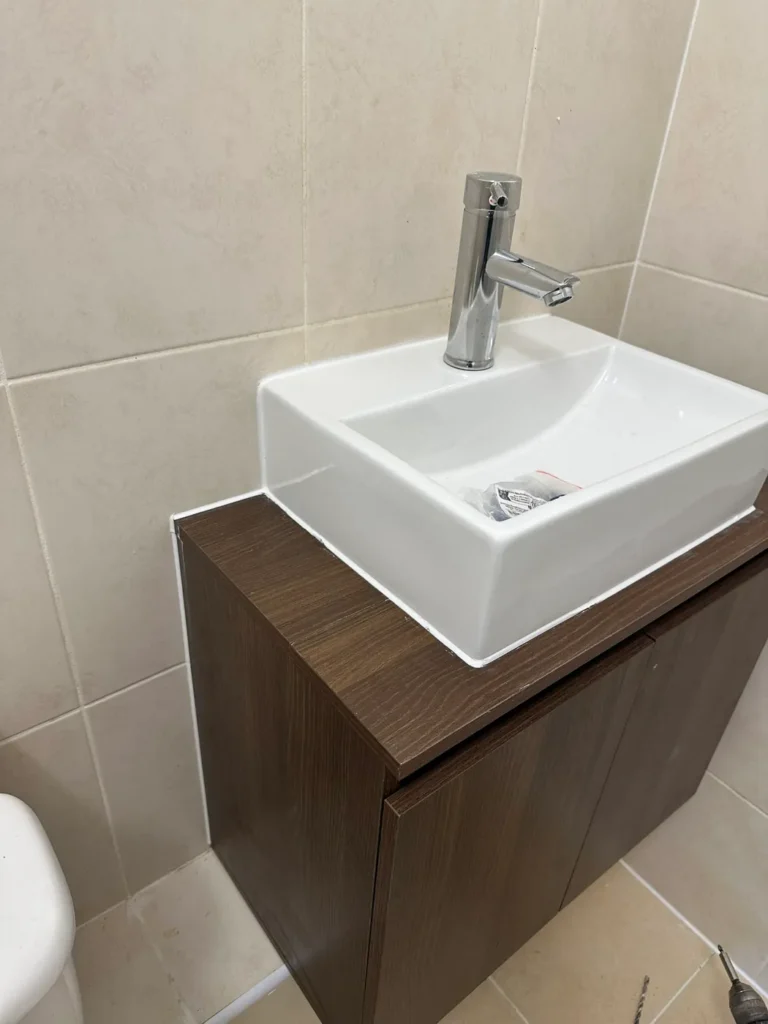 A new countertop basin on a walnut-effect unit, Deptford