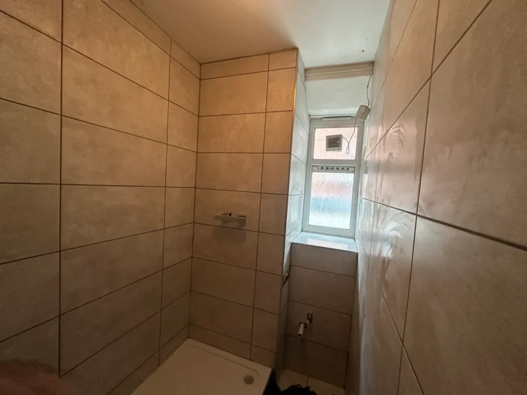 Large-format tiles around the window reveal, King's Park, Hackney