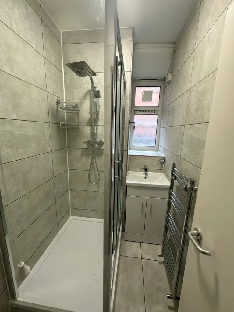 The finished shower room: tray, glass enclosure, rainfall shower and vanity unit, King's Park, Hackney