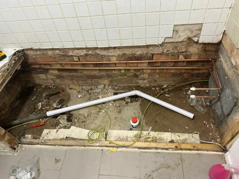 January 2026: the old bath out, exposing the pipework and floor beneath, Harrow Weald