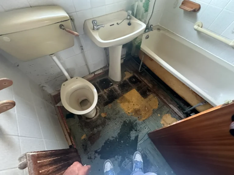 The original bathroom, with a damaged floor and dated suite, Blendon, Sidcup