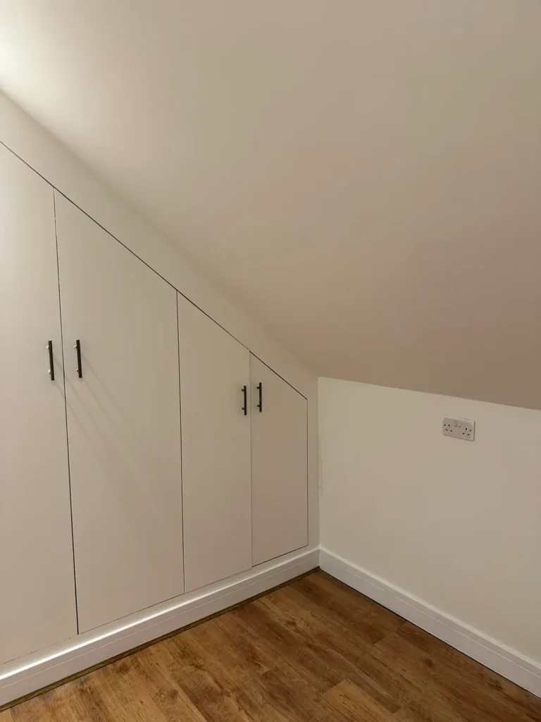 Wardrobe doors cut to the roof slope, Wexham Court, Slough