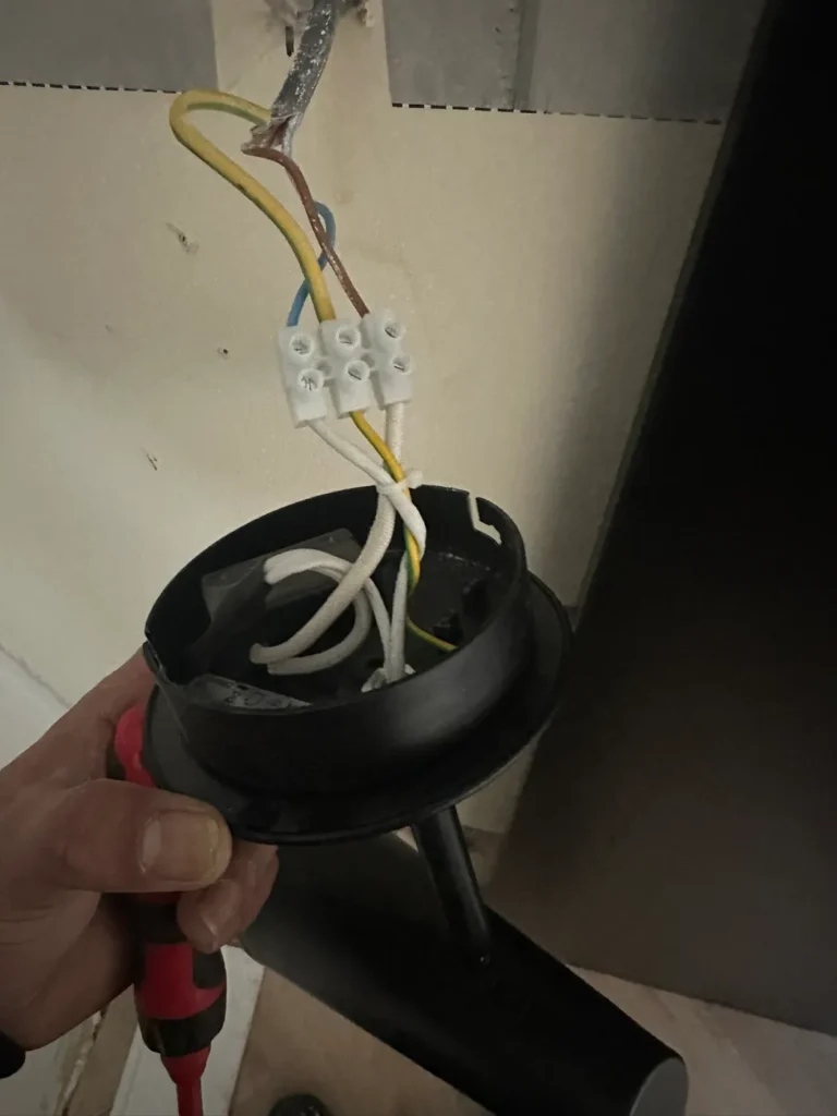 Rewiring a light fitting, Surrey Docks, Rotherhithe