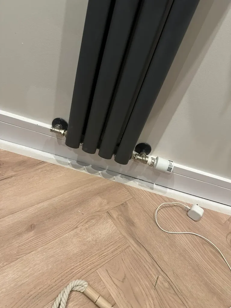 A new anthracite column radiator fitted, Surrey Docks, Rotherhithe