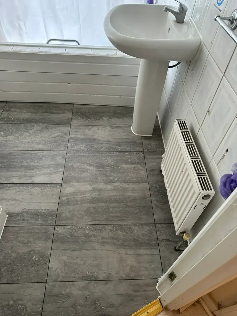 The bathroom floor relaid in large grey tiles, Wembley Hill, Wembley