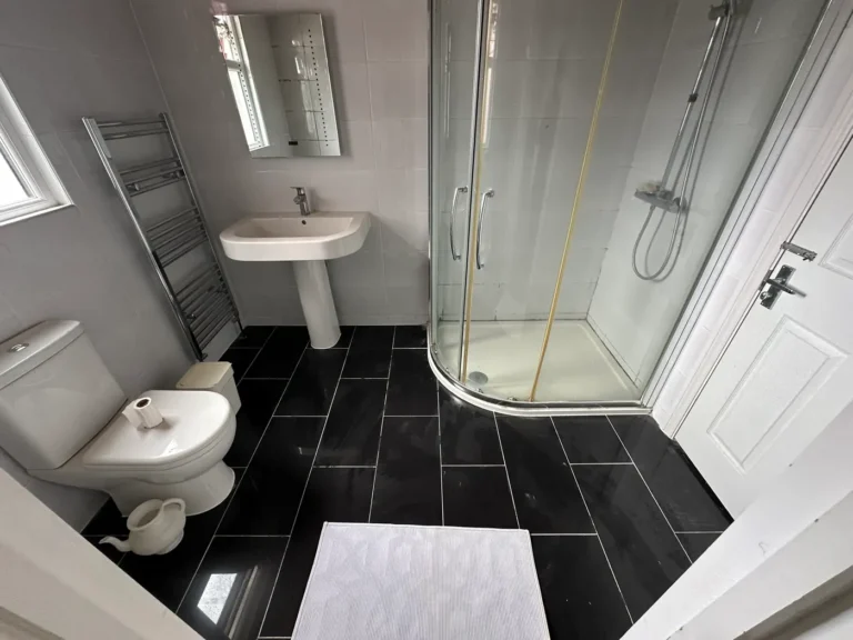 The finished shower room with a quadrant enclosure and new tiled floor, Wembley Central