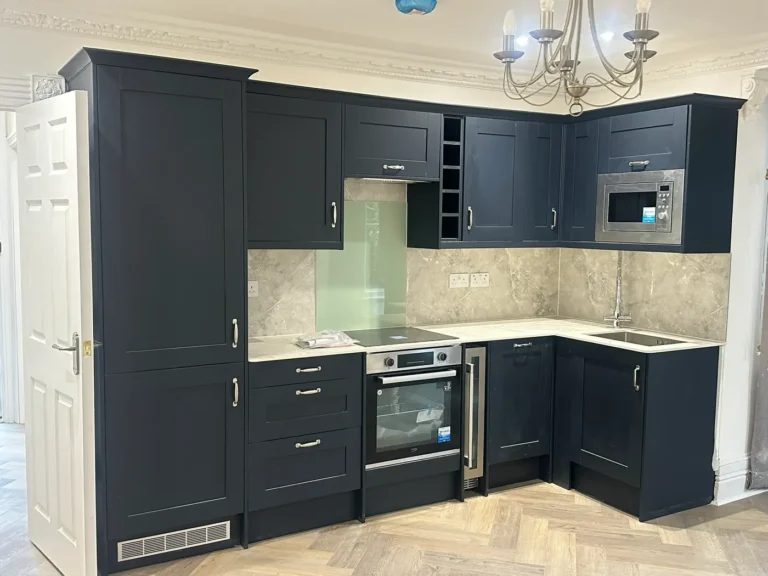A shaker-style kitchen in navy, with a built-in oven and microwave, Walpole, West Ealing