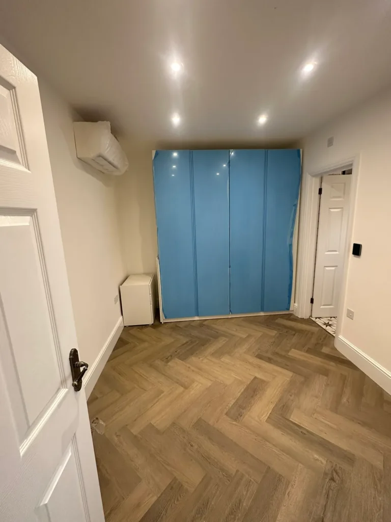 A bedroom with herringbone flooring and fitted wardrobes, Walpole, West Ealing