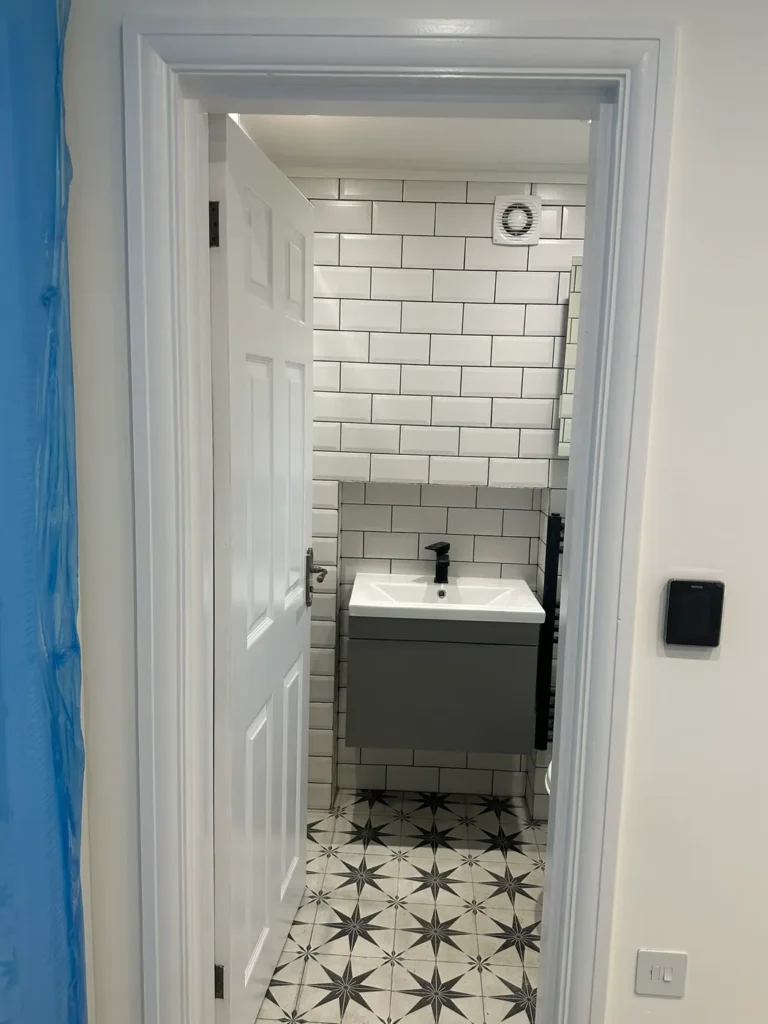 A shower room with a patterned floor and a grey vanity unit, Walpole, West Ealing