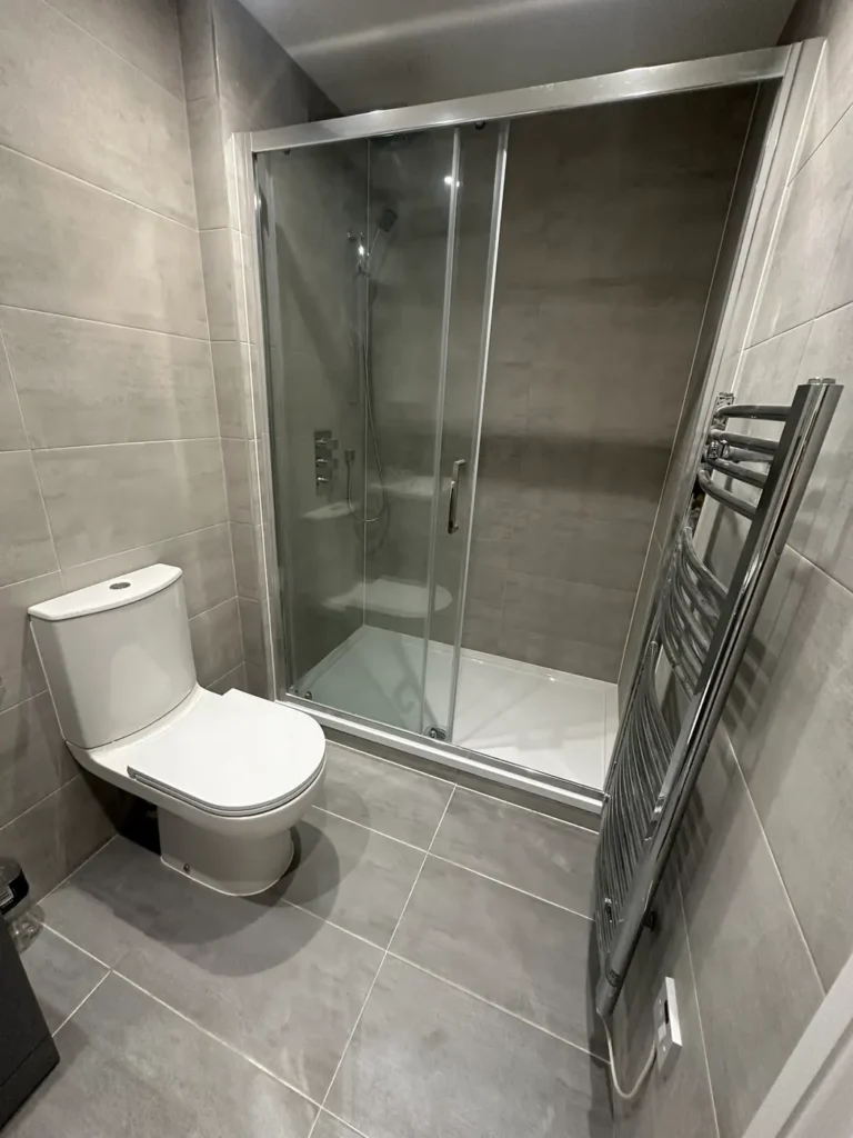 A shower room in large grey tiles with a walk-in enclosure, Walpole, West Ealing